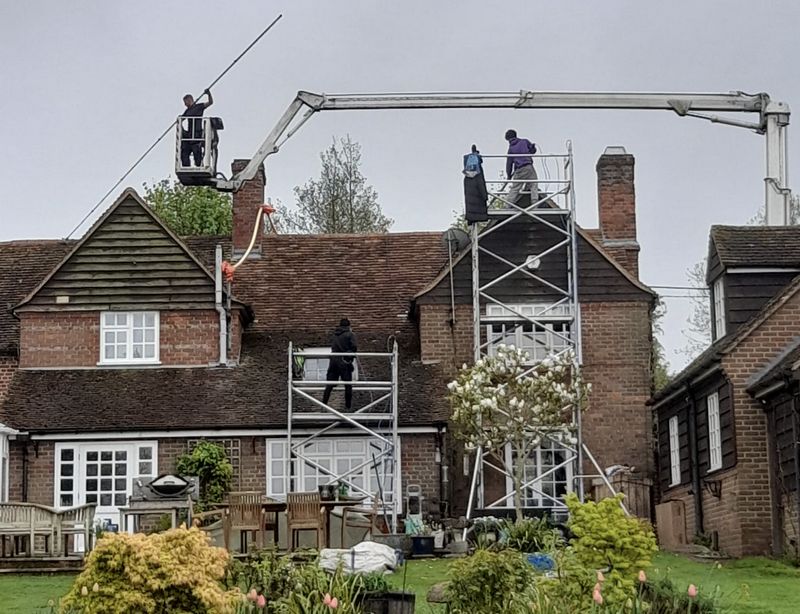 The Moss Cleaners using cherry picker and scaffolding to clean roof safely and professionally in London, 94 Disraeli Rd, London SW15 2DX, UK
